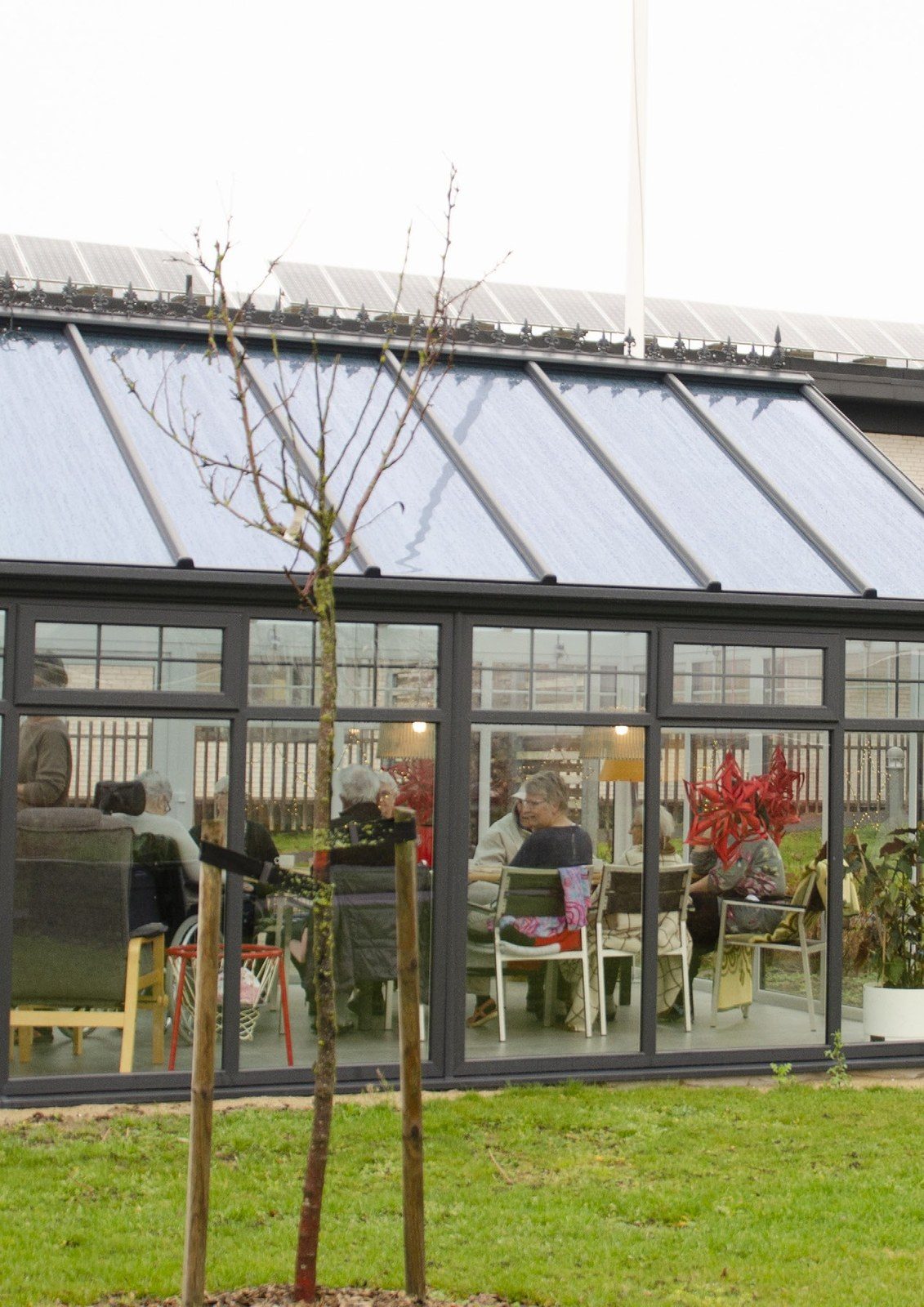 Residents together in a light-filled garden building
